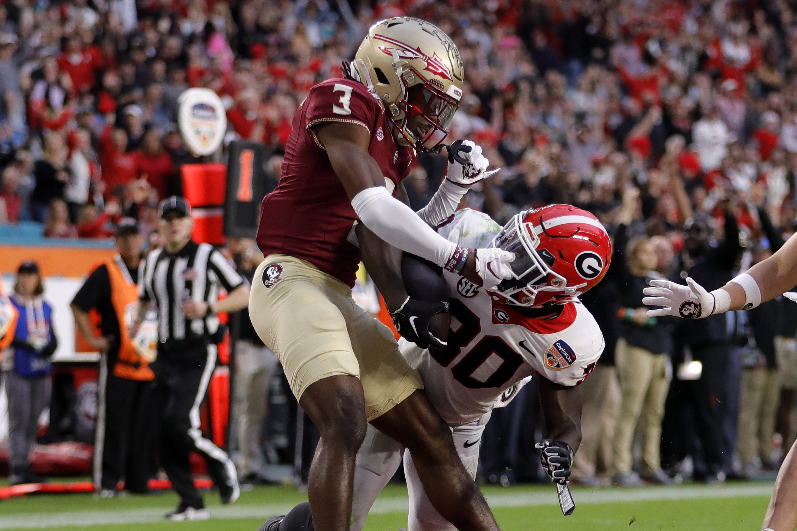 Dec 30, 2023; Miami Gardens, FL, USA; Georgia Bulldogs running back Daijun Edwards (30) scores a touchdown against Florida State Seminoles defensive back Kevin Knowles II (3) during the first half in the 2023 Orange Bowl at Hard Rock Stadium. (Sam Navarro / USA TODAY Sports).